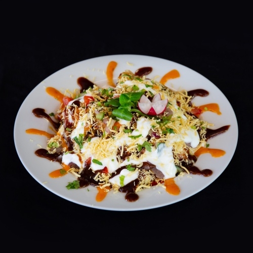 Papdi chaat with yogurt, tamarind sauce, and spices